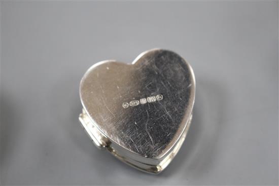 Three assorted modern silver pill boxes, including oval with hardstone lid, heart shaped and circular with shell inset lid, largest 4cm